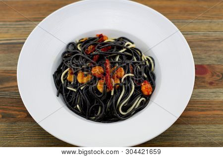 Italian Black Spaghetti, Alla Veneziana, With Grilled Prawns And Dried Tomatoes. With Olive Oil, Gar