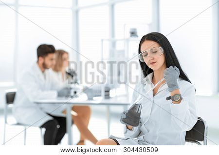 Close Up.woman Scientist Takes A Sample Of The Liquid .