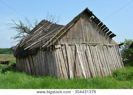 Old Rickety Wooden Barn After The Strong Wind.