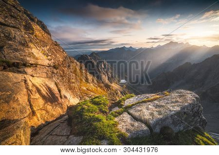 Mountains Landscape With Rock And Grass In Foreground At Sunrise. Bielovodska Valley As Seen From Se