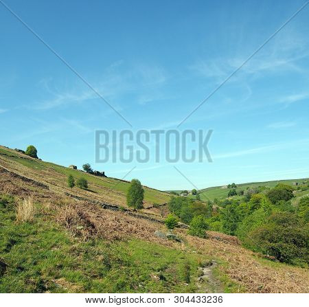 Hilly Green Fields With Grass Covered Pasture And Old Stone Farmhouses In The Yorkshire Dales At Cri