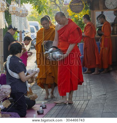 Lampeng, Tahiland - 2019-03-07 - Line Of Monks Receive Gifts Of Food From Worshippers Along Street.
