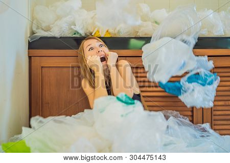 Woman Used Too Many Plastic Bags That They Filled Up The Entire Kitchen. Zero Waste Concept. The Con