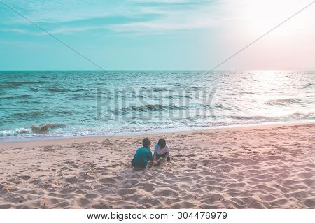 Two Siblings Children Is Playing With Wave And Sand In Pattaya Beach Thailand