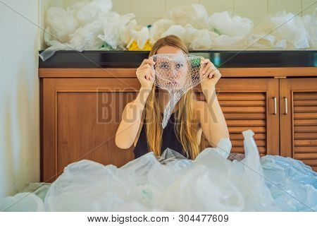 Woman Used Too Many Plastic Bags That They Filled Up The Entire Kitchen. Zero Waste Concept. The Con
