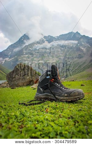 Sonmarg, Jammu And Kashmir, India: Date- May 20, 2019: Quechua Hiking Shoes Of A Hiker On Green Gras
