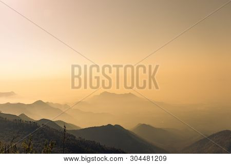 Misty Mountains Orange Sun Rays View Image Taken At Kodaikanal Tamilnadu India From Top Of The Hill.