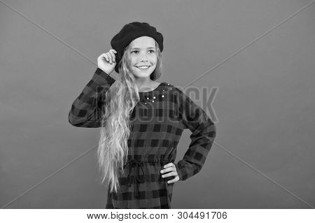 How To Wear Beret Like Fashion Girl. Kid Little Cute Girl With Long Hair Posing In Hat Red Backgroun