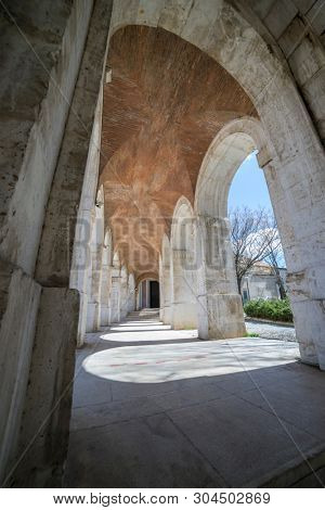 passage with columns and arches. Church of San Antonio in Aranjuez, Madrid, Spain. Stone arches and walkway linked to the Palace of Aranjuez