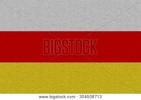 South Ossetia Flag Painted On Paper. Patriotic Background. National Flag Of South Ossetia