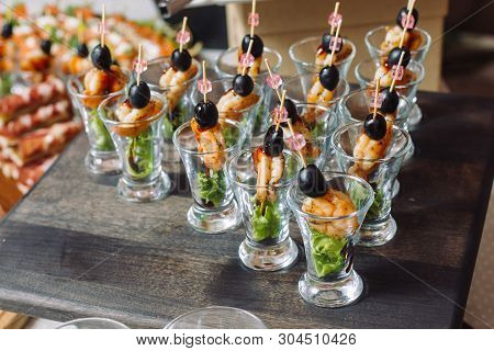 Kanape From Shrimps. Luxury Catering Exhibited On A Wooden Board.