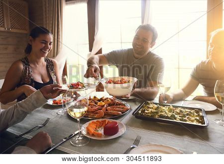 Close Up Of The Table With White Wine, Shrimps, Salad And Graten