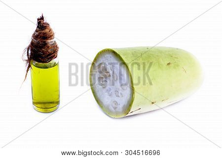Raw Organic Cut Half Bottle Gourd Isolated On White Along With Its Extracted Beneficial Oil In A Sma