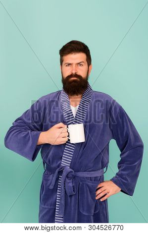 Bearded Man In Bathrobe With Mug. Breakfast Concept. Man With Beard In Blue Bathrobe Enjoy Morning C