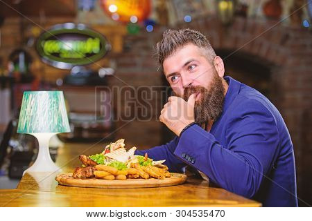 Hipster Hungry Eat Pub Fried Food. Man Received Meal With Fried Potato Fish Sticks Meat. High Calori
