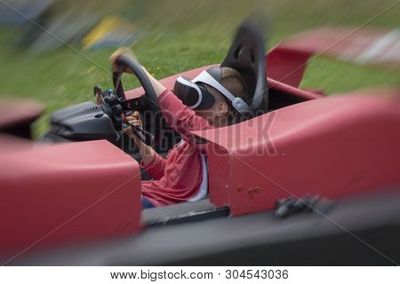 Child Wearing Vr Glasses Driving A Car