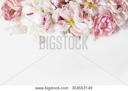 Close Up Of Fading Peonies And Pink Rose Flowers Petals Isolated On White Table Background. Floral F