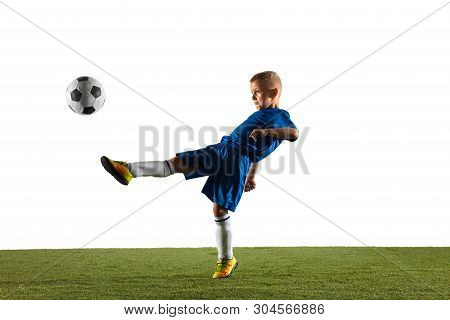 Young Boy As A Soccer Or Football Player In Sportwear Making A Feint Or A Kick With The Ball For A G