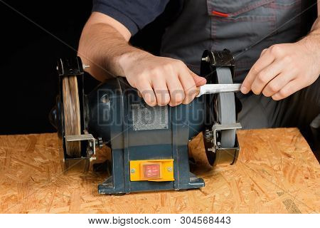 A Man In Working Clothes Hones Professional Sharpening Kitchen Knives