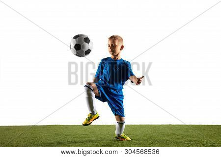 Young Boy As A Soccer Or Football Player In Sportwear Making A Feint Or A Kick With The Ball For A G
