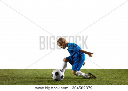 Young Boy As A Soccer Or Football Player In Sportwear Making A Feint Or A Kick With The Ball For A G