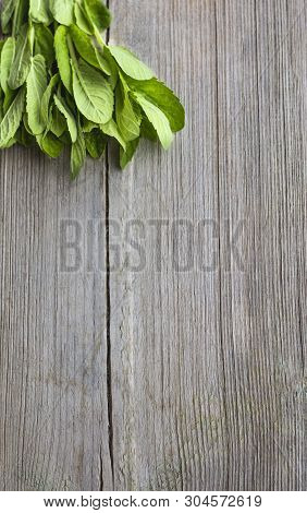 Bunch Of Fresh Mint On Wooden Surface With Copy Space