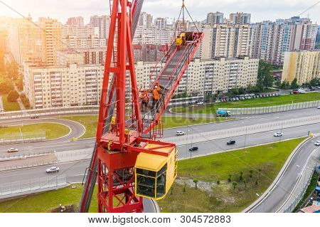 Installing The Jib Of A Construction Crane Using Another Crane On The Truck, The Work Of The Builder