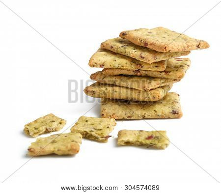Tasty diet cerel crispbread with seeds and spices: heap of whole  crackers and one broken isolated on a white background with copy space.