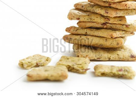 Tasty diet cerel crispbread with seeds and spices: heap of whole  crackers and one broken isolated on a white background