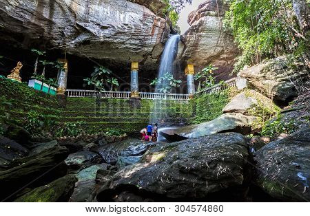 Motion Blurred Water And Children Play In  The Temple Under Waterfall Wat Tham Heo Sin Chai Waterfal
