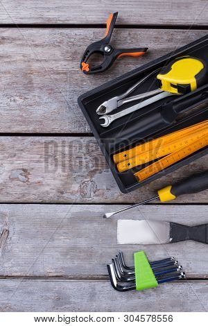 Tool Box With Different Tools On Wooden Background. Carpenter Tools And Instruments On Wooden Boards
