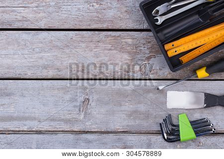 Various Construction Tools And Copy Space. Set Of Different Builder Tools On Wooden Background. Spac