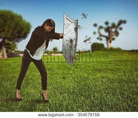 Woman Defends Herself From The Attack Of Mosquitoes With A Shield