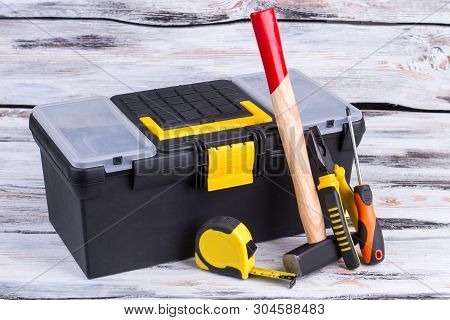 Tool Box And Different Tools On Wooden Background. Builder Ruler, Hammer, Pliers, Screwdriver And To