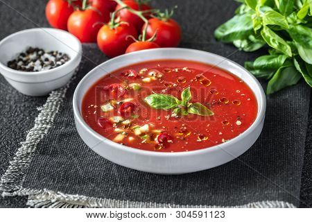 Portion Of Gazpacho With Ingredients On The Wooden Table