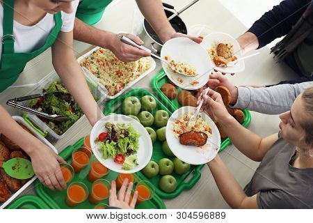 Volunteers Serving Food For Poor People Indoors, View From Above