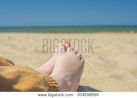 Bare Children's Feet On The Beach. Close-up