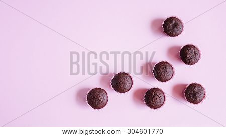 Chocolate Mini Cupcakes With No Frosting And Pink Background.