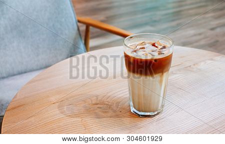 Iced Coffee Latte In Coffee Shop On Wooden Table.