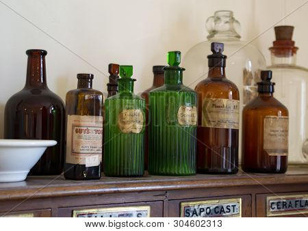 North Wales, Uk 4th Sept 2017 Close-up Of Old Brown And Green Glass Medicine Bottles On Drawer Cabin