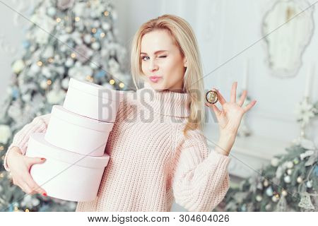 A Woman Holds Presents In Her Hands, In Her Other Hand A Bitcoin Coin.
