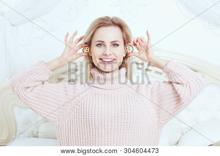 Woman Happily Smiles, Holds Bitcoins In Her Hands.