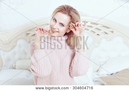 Young Smiling Woman Holds Bitcoin Coins In Her Hands.