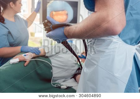 Doctor during endoscopy checking picture of mouth on screen in a modern hospital 