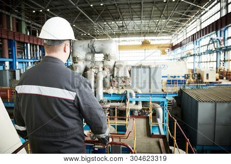 Power plant maintenance. Industial worker engineer