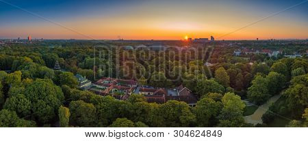 Famous Beergarden In The Bavarian Capital Munich, Germany At Sunset.