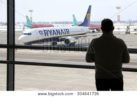 Boryspil, Ukraine - March 23, 2018: Man Watch Through The Window To The First Ryanair Plane Landed A