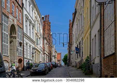 Luebeck, Germany - June 3, 2019: Narrow Cobblestone Street With Historic Houses In The Old Town Of L