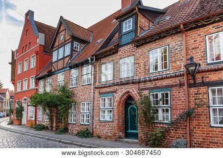 Street With Medieval Old Brick Buildings In Luneburg. Germany