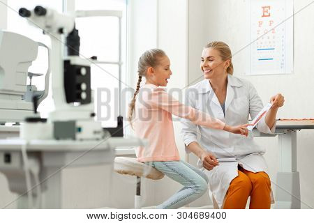 Active Young Girl Pointing On Elements Of Eye Presented On A Paper